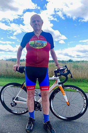A person holding a bicycleDescription automatically generated
