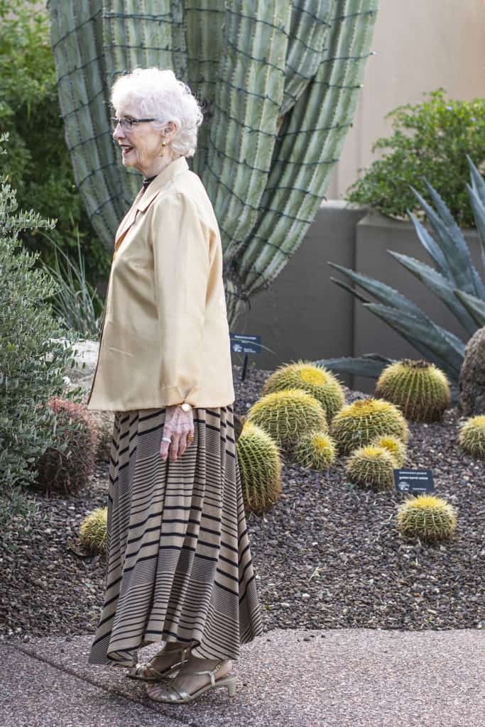 A person standing in a gardenDescription automatically generated
